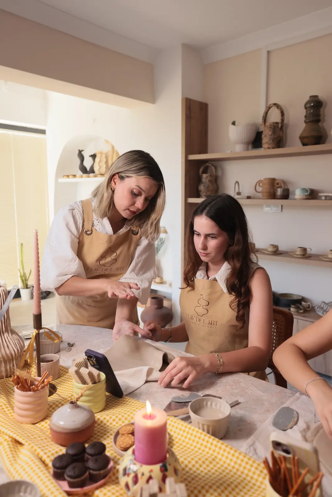 Atölyede elle seramik şekillendiren katılımcı